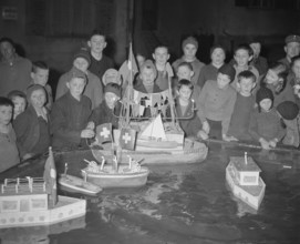 Boys playing with model boats, 1941