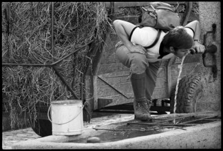 Hiker drinking water from a fountain, Switzerland 1971