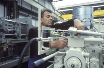 Worker assembling injection molding machine 1986
