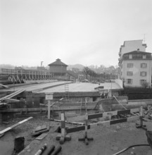 Neustadt bridge under construction, site fence; 1959