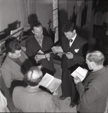 Men singing during mass on St. Barbara day in Salins