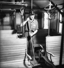 Railway official cleaning the third-class compartment, Lucerne in 1942