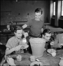 WW2: farming camp; young men eating, 1943