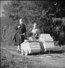 Women with riffles and prams on their way to the women's shooting competition in Urdorf, 1947