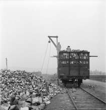 WW2: economy of war; inmates unloading used metal