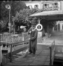 Man cleaning the landing stage after cattle transport, 1941