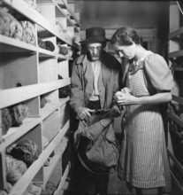 Woman choosing remnants, 1940