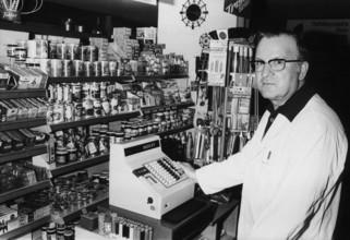 Sales person in food shop, around 1970