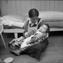 Tibetan woman feeding her baby, Waldstatt 1963