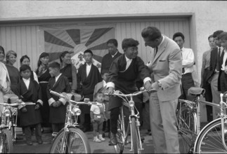 Ferdy Kübler presenting four bicycles to Tibetan pupils, Oetwil 1965