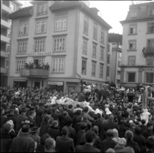Throwing bread to the crowd, carnival custom in Einsiedeln, 1965