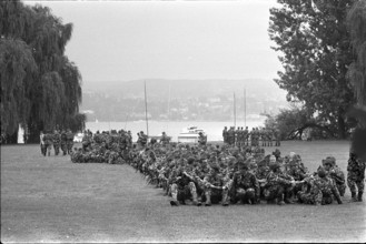 Military Parade 1969 in Switzerland: Soldiers having a rest in a park