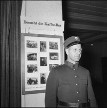 Watchman in front of advertising inside Kunsthaus Zurich 1954