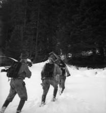 Woodcutters on their way to the forest; 1943