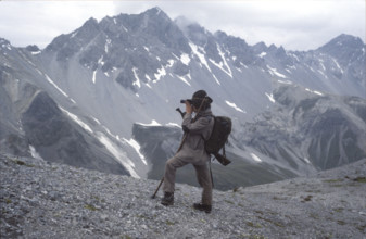 Hunter in the mountains, with field glasses, 1980