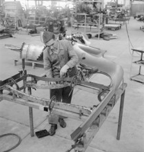Factory workers, assembly hangar; General Motors 1946