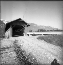 Roofed wooden bridge next to new built Rhine bridge; 1958