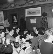 Family eating in restaurant in Payerne, 1946