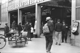 People standing in front of office for group tours; 1940