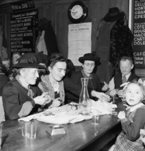 Family eating in restaurant in Payerne, 1946