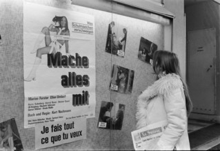 Woman watching the showcase of sex cinema Splendid, Geneva 1972