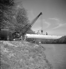 crane putting pontoon boat into Aare, Brugg 1950