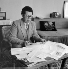 President of the local council P. Zenhäuser with letters of congratulation, 1957