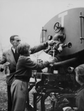 Refugees from Hungary drinking water out of tanker 1956