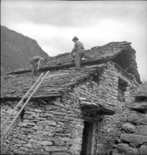 Frasco in the Verzasca valley, men repairing stone roof; 1942