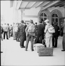 WW2: farming camp; men arriving at train station, 1942
