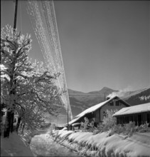 Lenk, iced over circuit line in snowy landscape; 1946