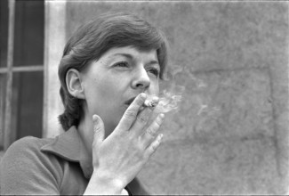 Woman smoking cigarette, 1973
