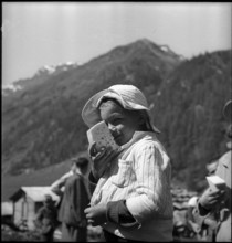 Farmer's boy with a slice of cheese in the Turtmanntal valley, Switzerland, 1940