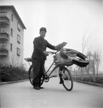 Postman with his bicycle; 1947
