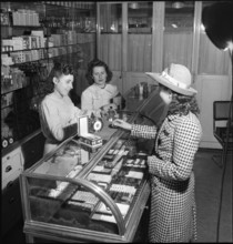 Vendors and customers in a boutique of cosmetics; 1942