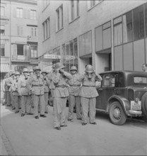 Call-up; soldiers pulling on gas mask; 1939.