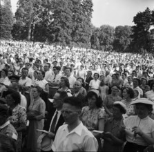 Audience listens to Baptist preacher Billy Graham in Geneva, 1955