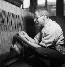 Man weaving a carpet, 1940