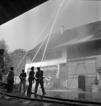 War fire brigade: Men extinguish fire; 1939