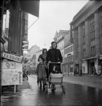 Woman with stroller walking; 1942