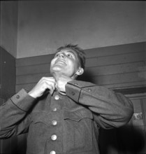 Recruit getting dressed, 1952