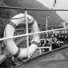 People at a boat dock in Ticino, 1953