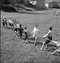 Children playing tug of war, 1942