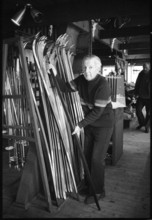 Swiss former skier Walter Prager in his ski shop, 1980