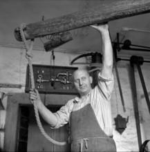 Frédéric Fauquex pressing wine on his estate in Riex, 1957