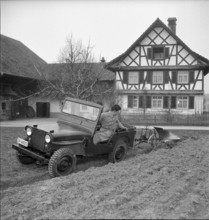 Military jeep pulling plow 1950