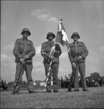 Three soldiers with the Swiss flag, Payerne 1949