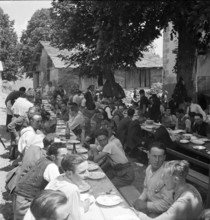 Men at a banquet in the Valais village of Ayent, 1943