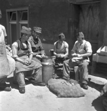 Soldiers peeling potatoes; 1943