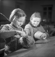 Children make pumpkin lanterns for school New Year's Eve 1945